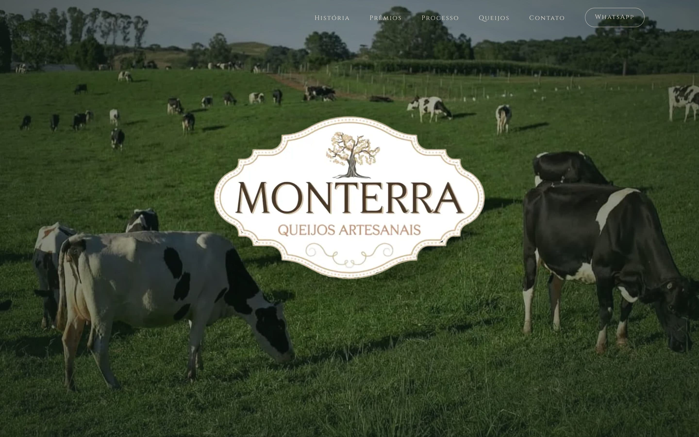 Monterra Queijos Artesanais home page with the logo over cows grazing in a green field